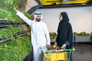 Emirati Couple Shopping for Fresh Vegetables in Supermarket