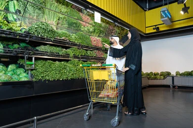 Emirati Couple Shopping for Fresh Vegetables in Supermarket