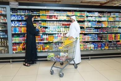 Emirati Couple Shopping in Modern Supermarket Aisle