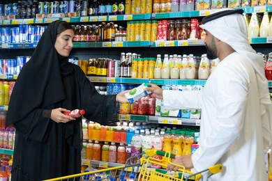 Emirati Couple Shopping in Supermarket Aisle