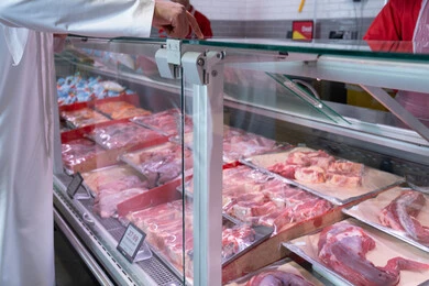 Emirati Man Choosing Meat at Supermarket Butchery