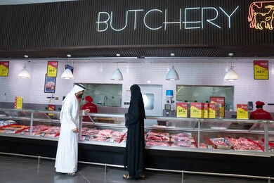 Emirati Couple Shopping at Supermarket Butchery Counter