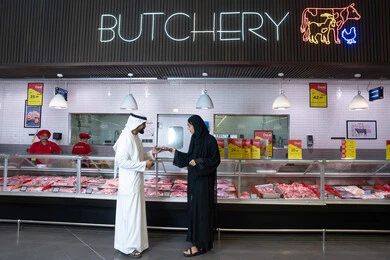 Emirati Couple Shopping at Supermarket Butchery Counter