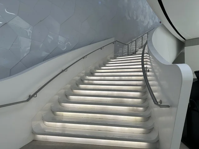 A staircase with a modern design inside the library, October 5, 2025, a place for readers and lovers of knowledge, books, and learning, the largest public library in Saudi Arabia, the King Abdulaziz Center for World Culture (Ithra) in Dhahran, Saudi Arabia, with books, novels, and stories arranged on the shelves.