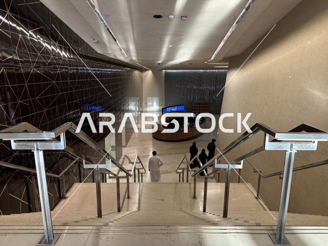 A man is using the stairs of the Ithra Center, October 5, 2025, a place for readers and lovers of knowledge, books, and learning, the largest public library in Saudi Arabia, the King Abdulaziz Center for World Culture (Ithra) in Dhahran, Saudi Arabia, with books, novels, and stories arranged on the shelves.