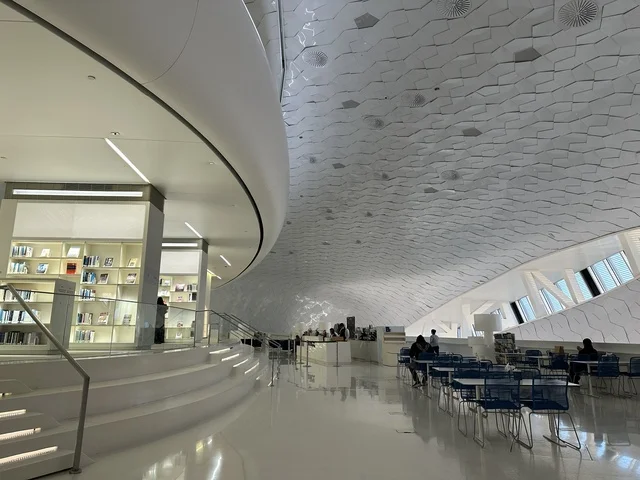 The interior design of the Ithra Library in Dhahran, October 5, 2025, a place for readers and lovers of knowledge, books, and learning, the largest public library in Saudi Arabia, the King Abdulaziz Center for World Culture (Ithra) in Dhahran, Saudi Arabia, with books, novels, and stories arranged on the shelves.