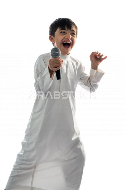 Portrait of a Saudi Arabian Gulf boy with Down syndrome holding the microphone, performing theatrical performances, having fun, theatrical lyrical art, caring for the abilities of people with special needs, capacity development, recreational activities fo
