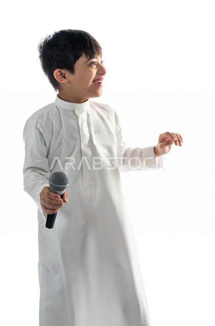 Portrait of a Saudi Arabian Gulf boy with Down syndrome holding the microphone, performing theatrical performances, having fun, theatrical lyrical art, caring for the abilities of people with special needs, capacity development, recreational activities fo