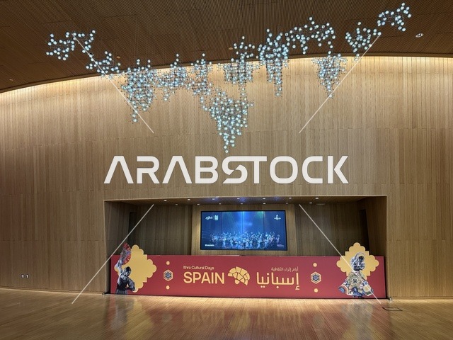 A modern electronic screen at the Spain Street event at the King Abdulaziz Center for World Culture "Ithra" in Dhahran, Eastern Province, Saudi Arabia, on October 11, 2025, featuring live musical and artistic performances, interactive activities for families and children, flamenco dances, Spanish-themed restaurants and cafes, and a vibrant festive atmosphere.