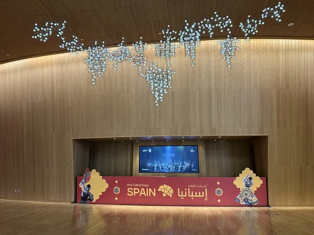 A modern electronic screen at the Spain Street event at the King Abdulaziz Center for World Culture "Ithra" in Dhahran, Eastern Province, Saudi Arabia, on October 11, 2025, featuring live musical and artistic performances, interactive activities for families and children, flamenco dances, Spanish-themed restaurants and cafes, and a vibrant festive atmosphere.