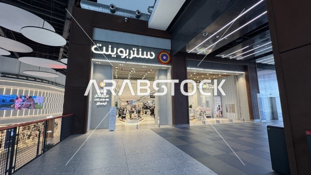 The Centerpoint store in the U Walk complex in Jeddah, Saudi Arabia, February 15, 2024, features an open walkway with a modern design, international and local restaurants and cafes, a comprehensive urban destination for walking, entertainment, and shopping, outdoor seating and social spaces, and a vibrant family and youth atmosphere.