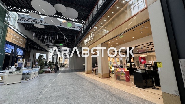 Global and local retail stores at the U Walk complex in Jeddah, Saudi Arabia, February 15, 2024, an open walkway with a modern design, restaurants and cafes, a comprehensive urban destination for walking, entertainment, and shopping, outdoor seating and social spaces, a vibrant family and youth atmosphere.