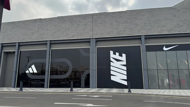 Nike brand at the U Walk complex in Jeddah, Saudi Arabia, February 15, 2024, an open walkway with a modern design, international and local restaurants and cafes, a comprehensive urban destination for walking, entertainment, and shopping, outdoor seating and social spaces, a vibrant family and youth atmosphere.