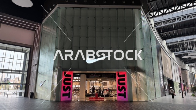 Nike brand at the U Walk complex in Jeddah, Saudi Arabia, February 15, 2024, an open walkway with a modern design, international and local restaurants and cafes, a comprehensive urban destination for walking, entertainment, and shopping, outdoor seating and social spaces, a vibrant family and youth atmosphere.