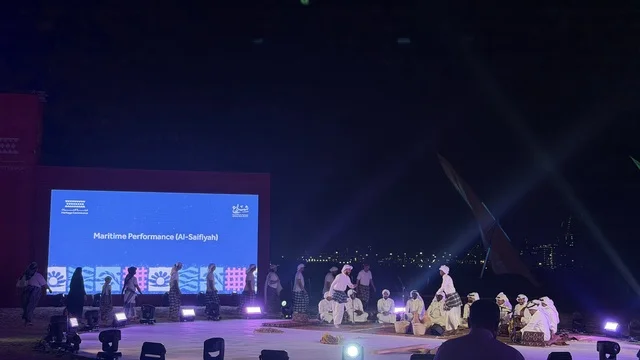 أداء حي على مسرح خارجي في الليل في مهرجان السفن الخشبية على شاطئ الحمراء بجدة في المملكة العربية السعودية 12 إلى 16 يناير 2026، عروض لمراحل بناء السفن التقليدية والأدوات والمواد المستخدمة،  التراث البحري والهوية الساحلية، الأنشطة التفاعلية والعروض الثقافية