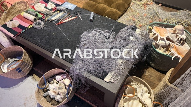 شبكة صيد رمادية متشابكة على الطاولة، مهرجان السفن الخشبية على شاطئ الحمراء بجدة في المملكة العربية السعودية 12 إلى 16 يناير 2026، عروض لمراحل بناء السفن التقليدية والأدوات والمواد المستخدمة،  التراث البحري، الأنشطة التفاعلية والعروض الثقافية