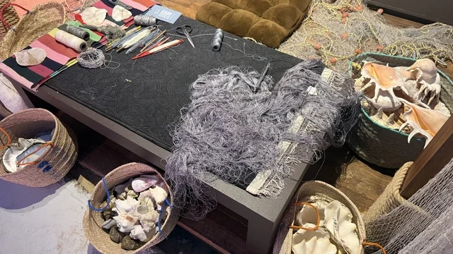 A tangled gray fishing net on the table, the Wooden Ships Festival on the Al-Hamra Beach in Jeddah, Saudi Arabia from January 12 to 16, 2026, showcases the stages of traditional shipbuilding, the tools and materials used, maritime heritage, interactive activities, and cultural performances.