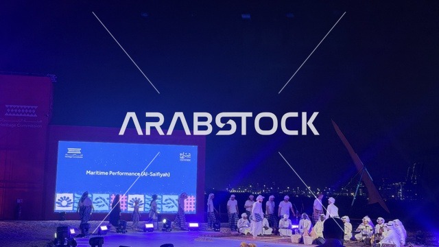 A large display at the Wooden Ships Festival on the Al-Hamra Beach in Jeddah, Saudi Arabia, from January 12 to 16, 2026, featuring presentations on the stages of traditional shipbuilding, the tools and materials used, maritime heritage and coastal identity, interactive activities, and cultural performances.