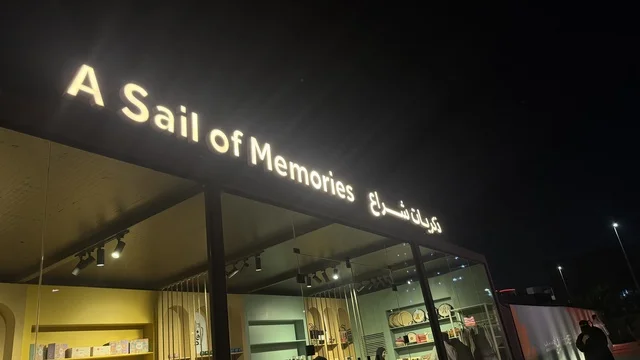 A sign on an outdoor store at the Wooden Ships Festival on Al-Hamra Beach in Jeddah, Saudi Arabia, from January 12 to 16, 2026, showcasing the stages of traditional shipbuilding, the tools and materials used, maritime heritage and coastal identity, interactive activities, and cultural performances.