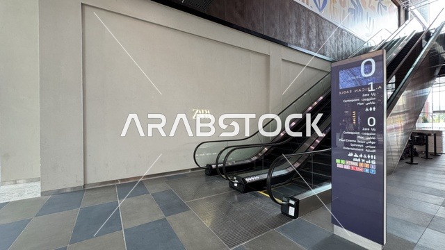 The escalator at the U Walk complex in Jeddah, Saudi Arabia, February 15, 2024, an open walkway with a modern design, international and local restaurants and cafes, a comprehensive urban destination for walking, entertainment, and shopping, outdoor seating and social spaces, a vibrant family and youth atmosphere.