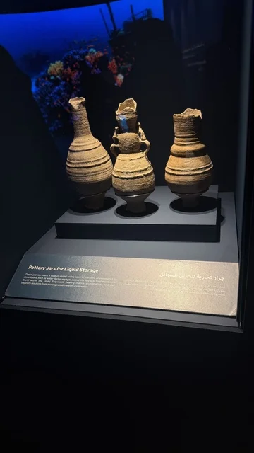 A jar displayed in a museum environment, exhibitions of the stages of traditional shipbuilding and the tools and materials used, the wooden ships festival on the Al-Hamra beach in Jeddah, Saudi Arabia from January 12 to 16, 2026, maritime heritage, interactive activities, and cultural performances.