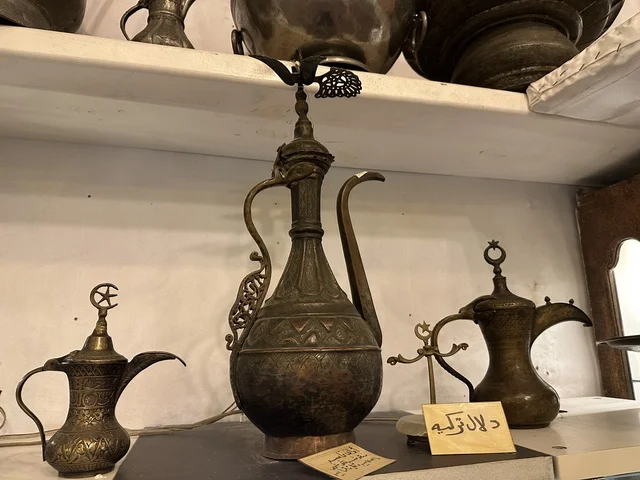 Heritage utensils at the Al-Falwah and Al-Jawhara Museum in the Al-Nuzha neighborhood of Dammam, Eastern Province, Kingdom of Saudi Arabia, on February 21, 2018, a distinctive educational and tourist destination, Saudi heritage, classic cars, a heritage and cultural landmark showcasing the history of traditional clothing and jewelry, documentation of handicrafts and Saudi identity, Islamic art.