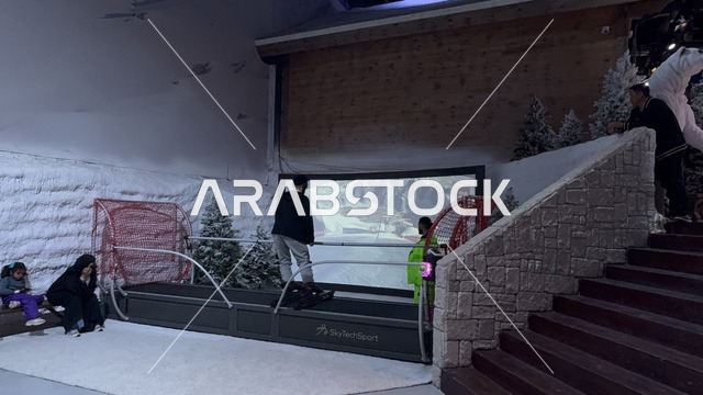 A child practices skiing in the Korfchevel experience in the Boulevard World area in Riyadh, Saudi Arabia, on November 25, 2025. Snowy decor and a mountainous scene create a luxurious atmosphere that combines entertainment and relaxation. A winter entertainment event inspired by the ambiance of European ski resorts, with winter-themed restaurants and cafes, and enjoyable interactive activities.