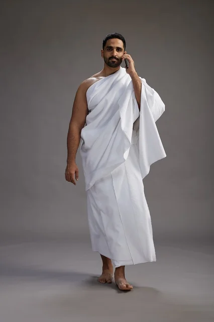 بورتريه لرجل سعودي بملابس الإحرام يجري مكالمة هاتفية عبر الهاتف المحمول, الاستعداد لاداء مناسك الحج والعمره, الجسم بالطول الكامل , خلفيه رماديه بورتريه لرجل سعودي بملابس الإحرام يجري مكالمة هاتفية عبر الهاتف المحمول, الاستعداد لاداء مناسك الحج والعمره, الجسم بالطول الكامل , خلفيه رماديه