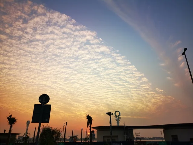 The clouds and skies at sunset, the coastal waterfront in the city of Dubai, the landscapes at Al Mamzar Beach, famous landmarks in the United Arab Emirates, a tourist destination to attract and draw in tourists.