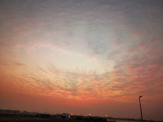The clouds and skies at sunset, the coastal waterfront in the city of Dubai, the landscapes at Al Mamzar Beach, famous landmarks in the United Arab Emirates, a tourist destination to attract and draw in tourists.