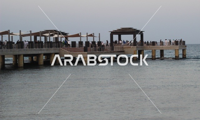 The waterfront in the city of Jeddah, Saudi Arabia, Jeddah Corniche, famous tourist attractions, enjoying quiet sessions overlooking the sea, and the focus on planting green palm trees in coastal cities.