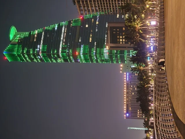 The Kingdom Tower in Riyadh, Saudi Arabia, illuminated in green at night, events and celebrations of the Saudi National Day 92, famous landmarks of Riyadh, tourism in Saudi Arabia.
