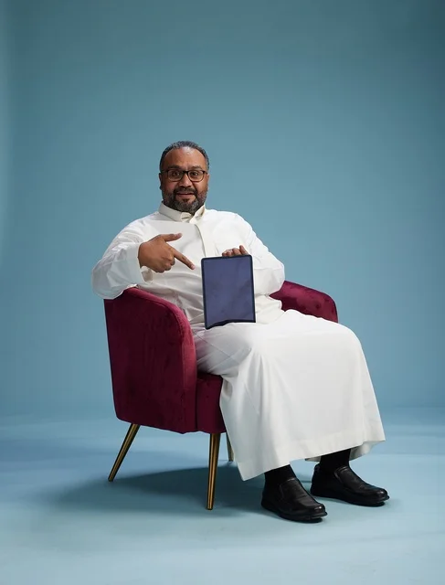 A Saudi man in traditional attire holding a tablet, using the mobile tablet, various gestures and movements, blue background.