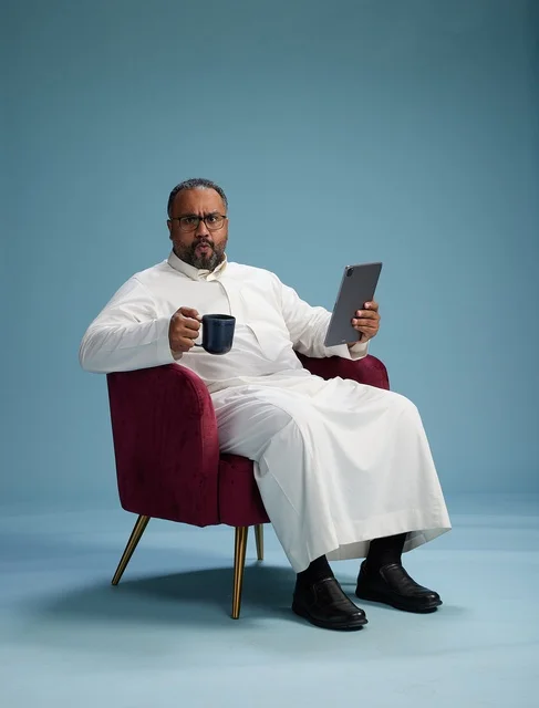 A Saudi man in traditional attire holding a tablet, using the mobile tablet, various gestures and movements, blue background.