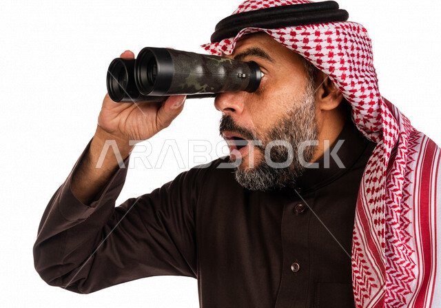 بورتريه لرجل عربي خليجي سعودي ينظر من خلال الناظور، إيماءات وجه تدل على الدهشة والتعجب، الاستكشاف والمغامرة، فريق الكشافة، رؤية مستقبلية، التخطيط المستقبلي، اهداف وطموحات، خلفية بيضاء