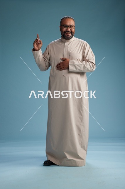 A smiling Saudi man wearing a beige thobe with various hand gestures and movements, full body, blue background.