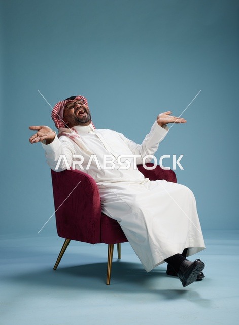 A portrait of a Saudi man wearing a white thobe and a shemagh, gesturing with his hand while sitting on a red chair, with various gestures and movements, against a blue background.