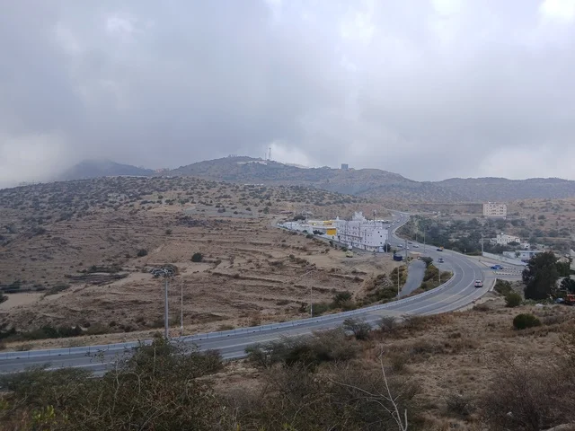 The residential houses and the paved roads in the city, the famous historical tourist attractions, the Al-Bahah area in the archaeological village of Dhai Ain in the south of the Kingdom of Saudi Arabia, the green trees and plants surrounding the village on the highlands and mountain peaks.