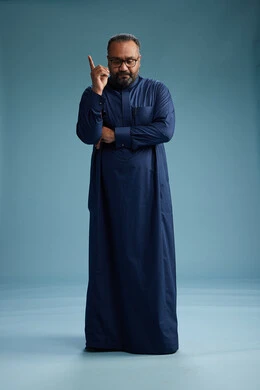 A portrait of a Saudi man standing wearing a navy blue thobe, making various gestures and movements, standing full body, with a blue background.