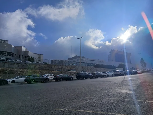 Parking for medical centers in the mountainous area, King Fahd Hospital Road in Al-Baha, health centers, hospitals, and patient care facilities in the Kingdom of Saudi Arabia, preparing and equipping cities in the mountains, peaks, and rocky elevations.