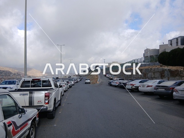 The road to King Fahd Hospital in Al-Baha, the parking lot for medical centers in the mountainous area, health centers, hospitals, and patient care facilities, in the Kingdom of Saudi Arabia, preparing and equipping cities in the mountains, peaks, and rocky elevations.