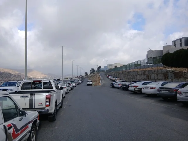 The road to King Fahd Hospital in Al-Baha, the parking lot for medical centers in the mountainous area, health centers, hospitals, and patient care facilities, in the Kingdom of Saudi Arabia, preparing and equipping cities in the mountains, peaks, and rocky elevations.