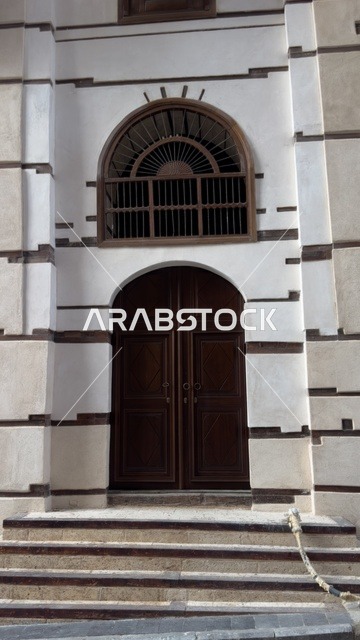 The historical buildings in the historic district of Jeddah in the Kingdom of Saudi Arabia, the alleys of the historic district in Jeddah, ancient Arab architectural design, archaeological buildings, historical landmarks in Jeddah, tourism in Saudi Arabia.