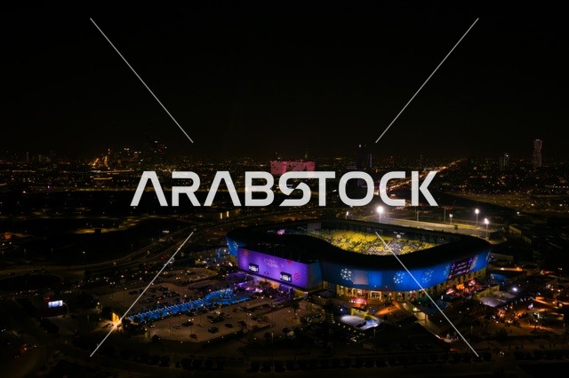 تصوير درون جوي لملعب الأول بارك في مدينة الرياض، المملكة العربية السعودية، منشأة رياضية حديثة متعددة الاستخدامات، المباريات والفعاليات الرياضية الكبرى، تصميم معماري عصري ومرافق متطورة، وجهة رياضية وترفيهية بارزة في العاصمة.