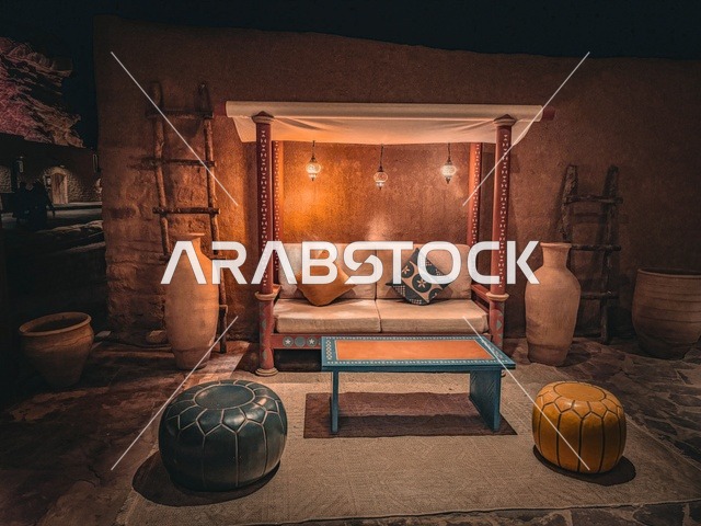 A heritage session in the old town of Al-Ula, Saudi Arabia, featuring traditional decor that reflects the historical character and ancient life, popular furnishings, and pottery. A warm atmosphere inspired by authentic Saudi heritage, a cultural experience that expresses the authenticity of the place and the depth of history.