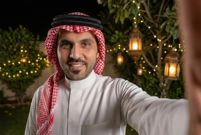 شهر رمضان المبارك، رجل عربي خليجي سعودي يرتدي الزي التقليدي والشماغ  يلتقط صورة سيلفي تذكارية ، إضاءة وزينة شهر رمضان، أجواء رمضانية، مناسبات دينية ، اسلاميات وعبادات