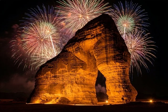 The rock formations in the city of Al-Ula in the Kingdom of Saudi Arabia, the Elephant Rock in Al-Ula, the launch of fireworks and firecrackers in the Saudi sky at night, the celebratory entertainment events for holidays and occasions, the celebration of New Year's Eve 2026.