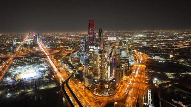 Aerial drone footage of the King Abdullah Financial Center (KAFD) in Riyadh, Saudi Arabia, featuring towers and skyscrapers, the capital of Riyadh, famous tourist landmarks of Riyadh, the skyline of the city, roads and streets of Saudi Arabia.