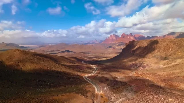 The formations and rock structures in the mountainous valleys of famous historical archaeological sites, a winding road that cuts through the mountains in Wadi Al-Disa in the Tabuk region, the land of palm trees and enchanting springs, mountain ranges and natural landmarks in Saudi Arabia, the tourist areas in the Kingdom.
