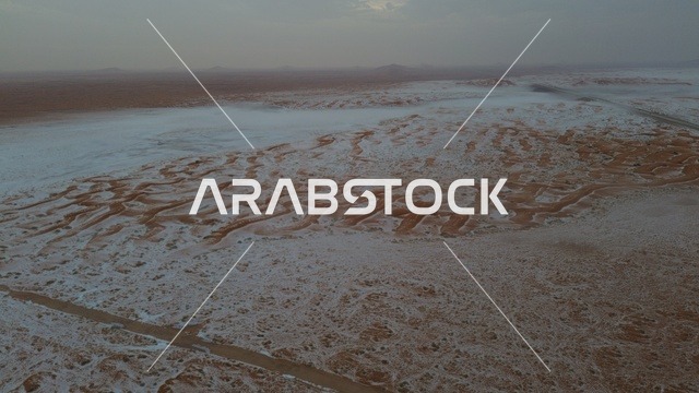 The desert nature in the Kingdom of Saudi Arabia is covered with snow, a mountainous area blanketed in white snow, scenic views.